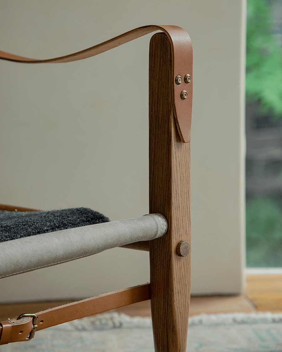 Safari Chair detail: US Red Oak frame, leather and brass accents, canvas seat support - portable design