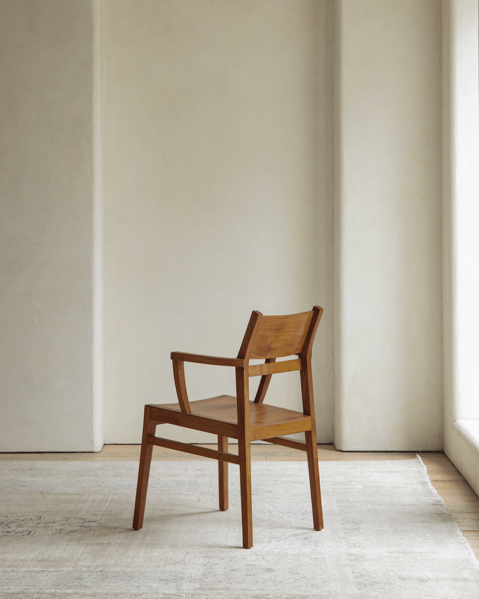 Hug Chair, wooden armchair with modern design, warm wood tones, and elegant form, perfect for any living space.