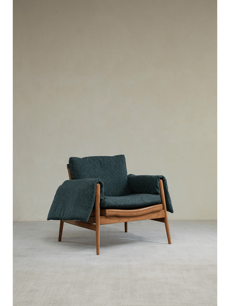 Teak wood garden lounge chair with teal cushion and blanket, modern design, indoor or outdoor use