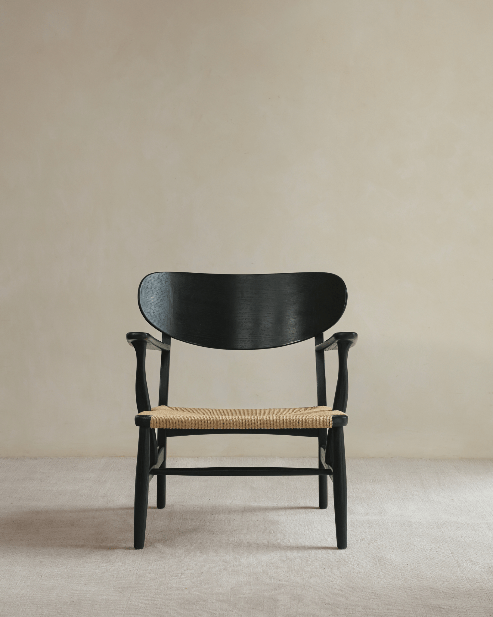 CH22 Lounge Chair with black frame and woven paper cord seat; Scandinavian design icon