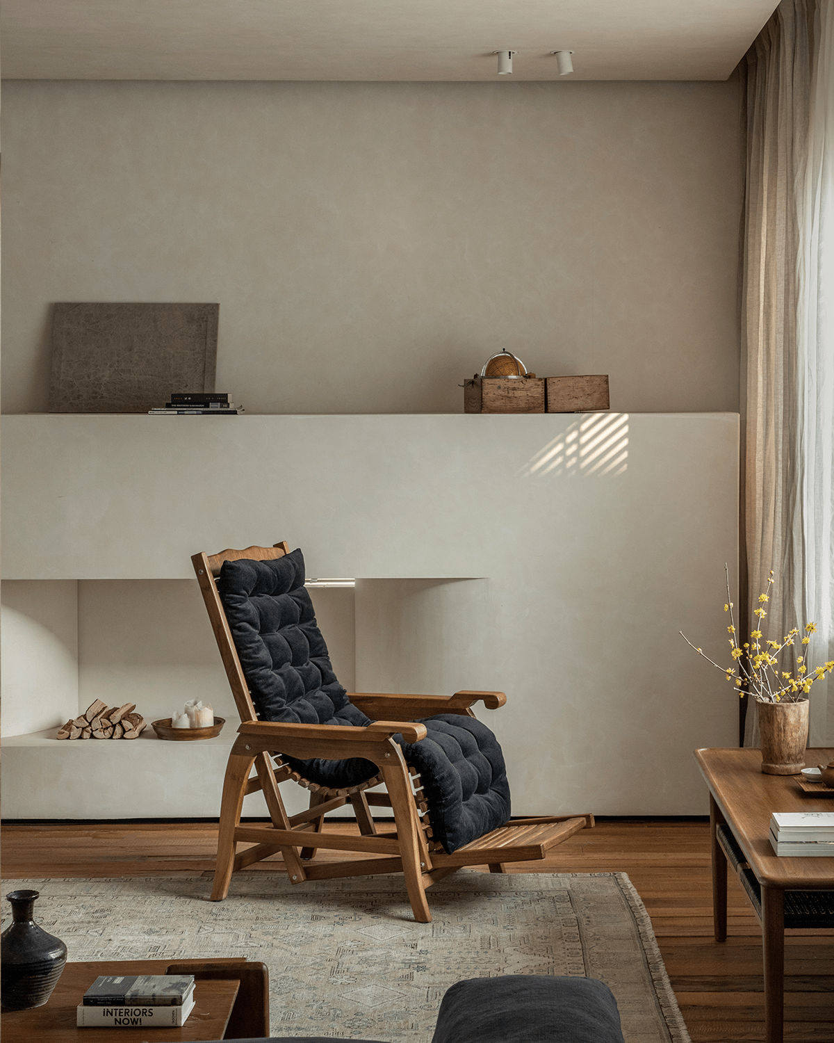 Roller Chaise Lounge in teak wood with black cushion; perfect for relaxation and interior styling