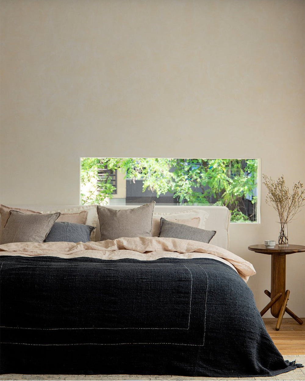 Dark gray cotton blanket on bed, cotton with white stitch detail, perfect for home decor