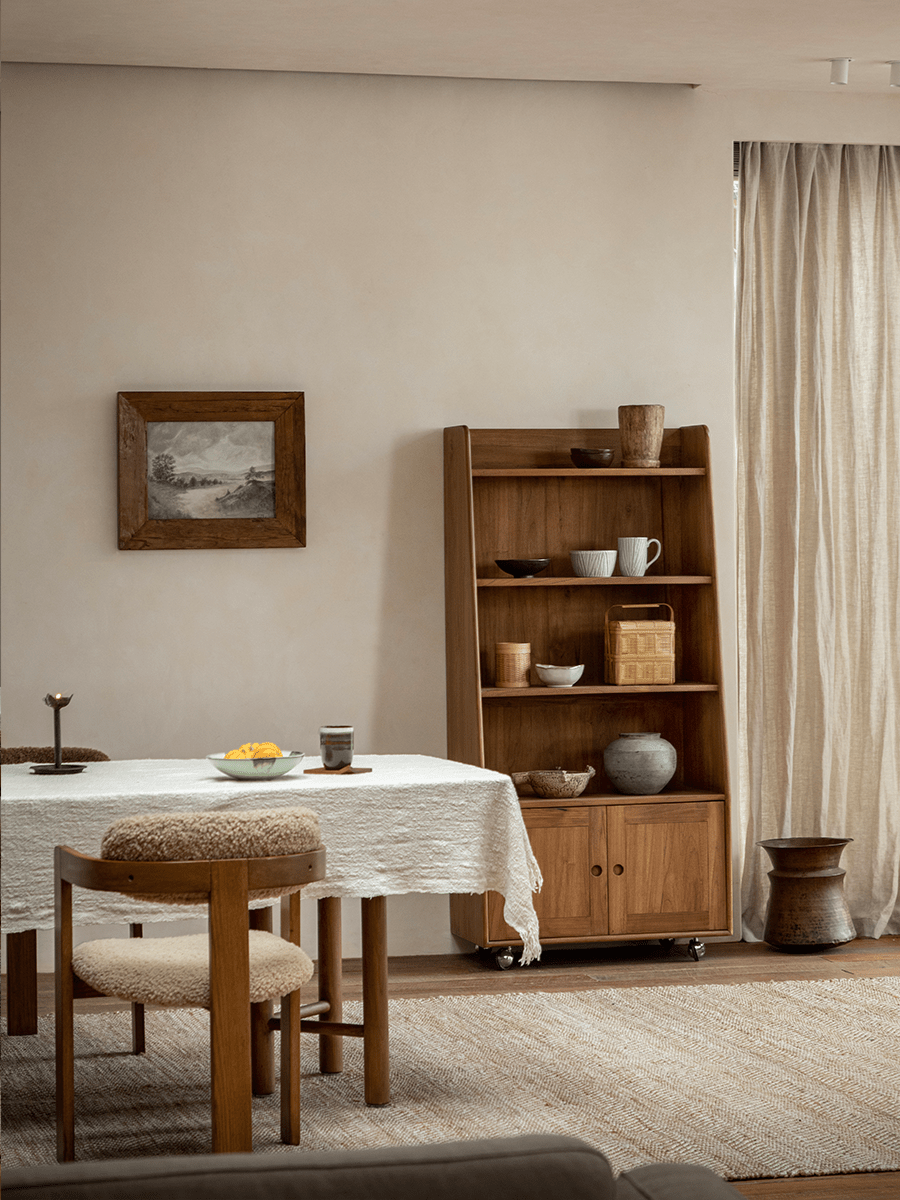 Teak Lidi Display Cabinet styled in a modern living room, featuring adjustable shelves, wheels, and modern interior design.