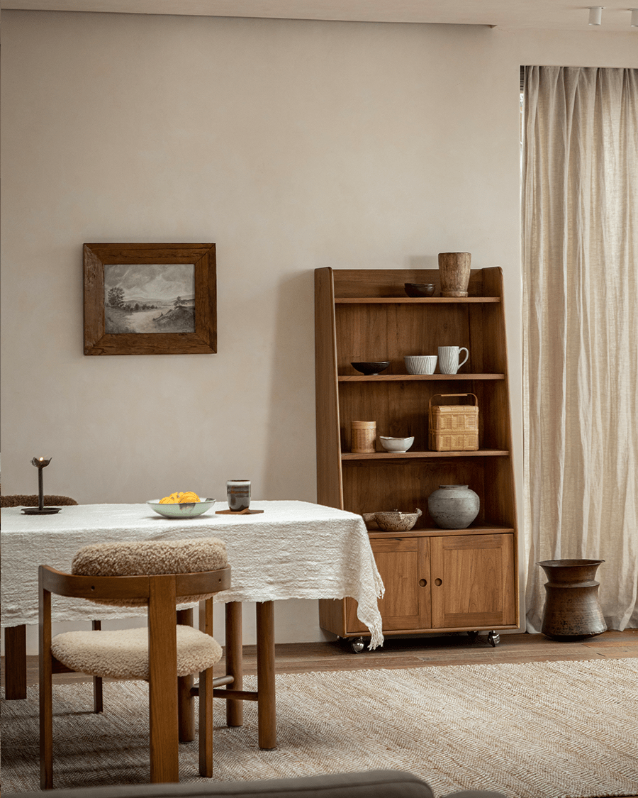 Teak Lidi Display Cabinet styled in a modern living room, featuring adjustable shelves, wheels, and modern interior design.