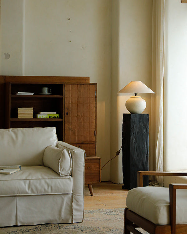 Clay moon lamp with beige lampshade, dark base stand, and white sofa, perfect for bedside or living room lighting