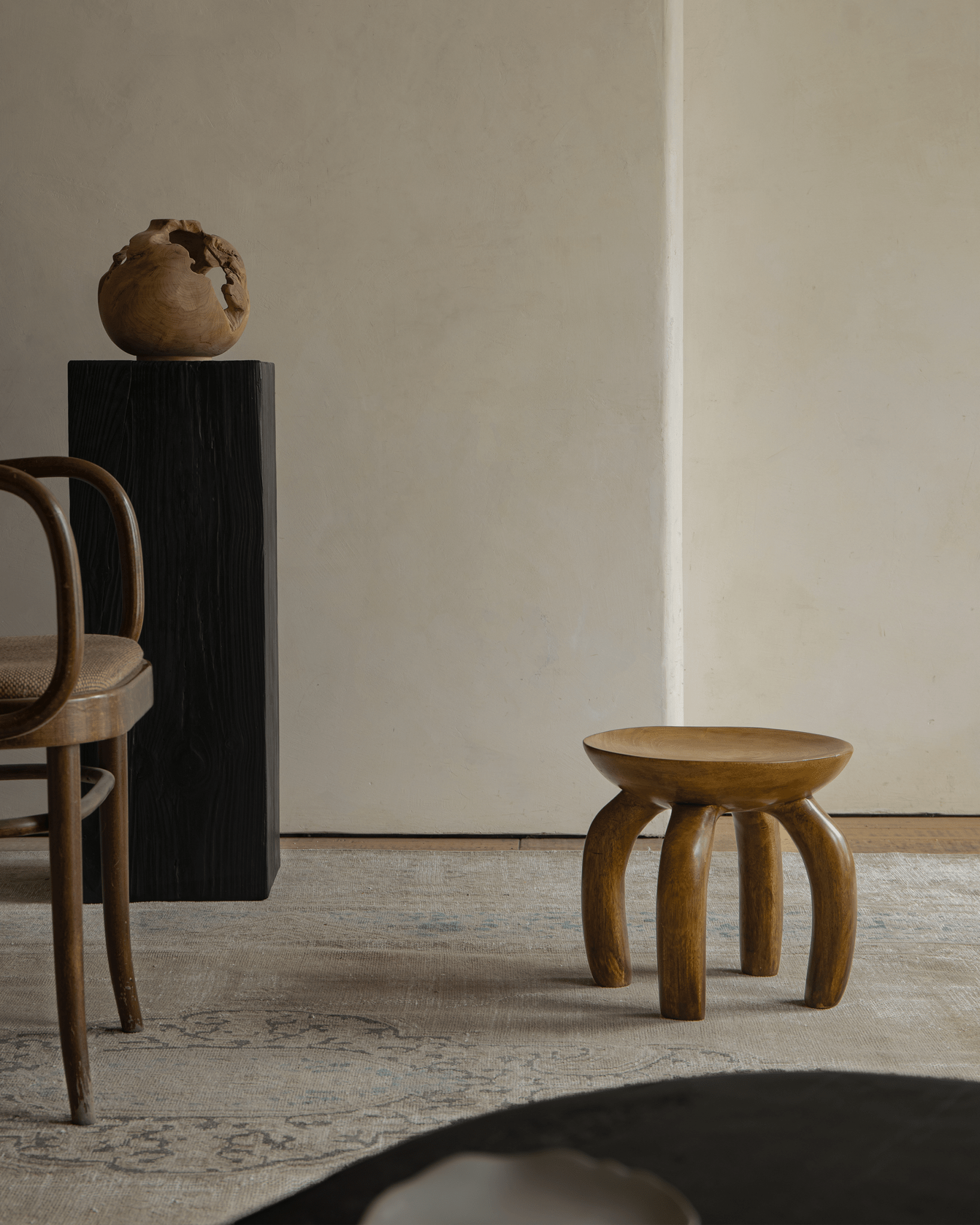 Jelly Stool in living room setting. Handcrafted solid wood sustainable furniture, unique design and elegant style.