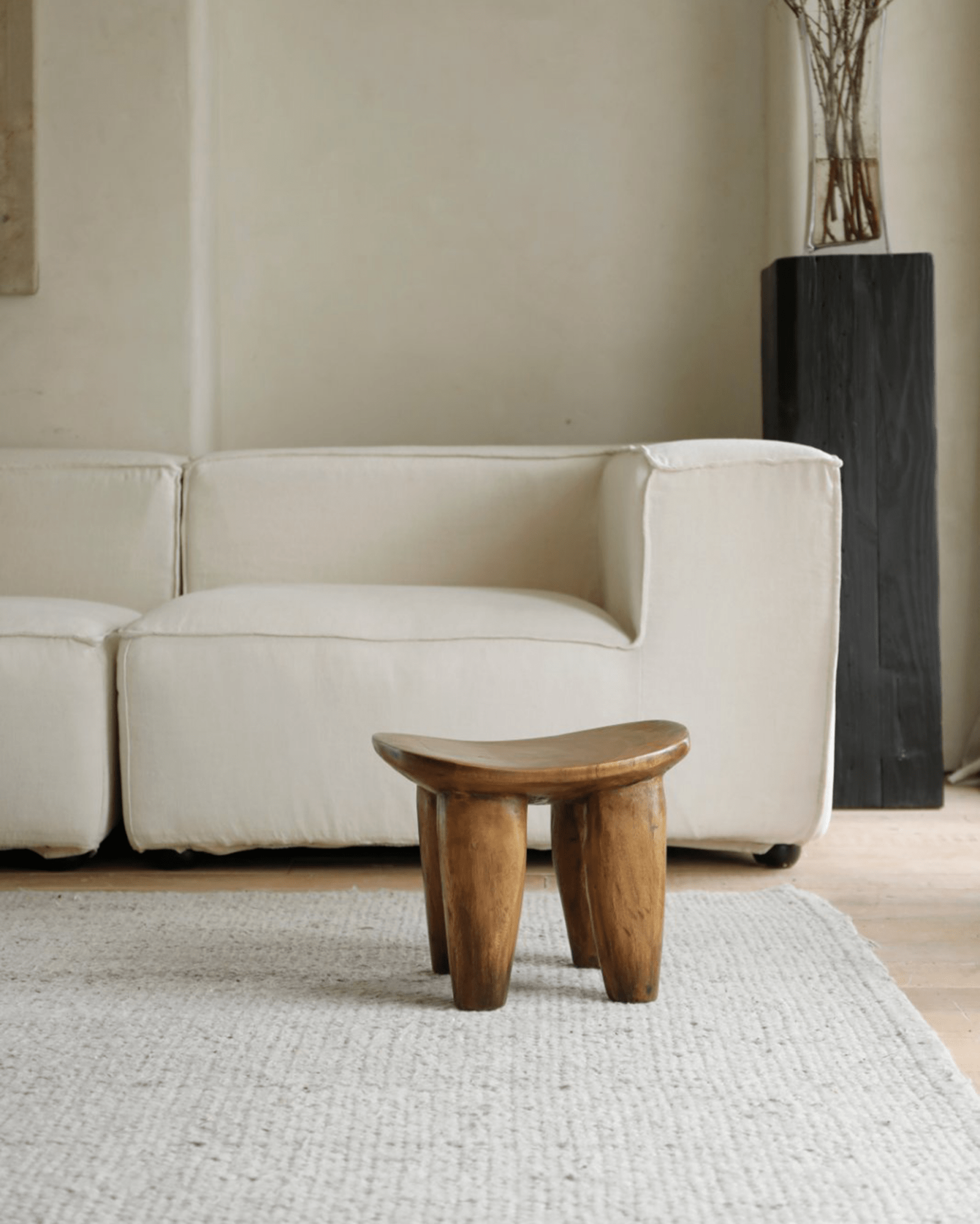 Samanea saman milk stool in living room, natural wood finish, minimalist decor, product shot