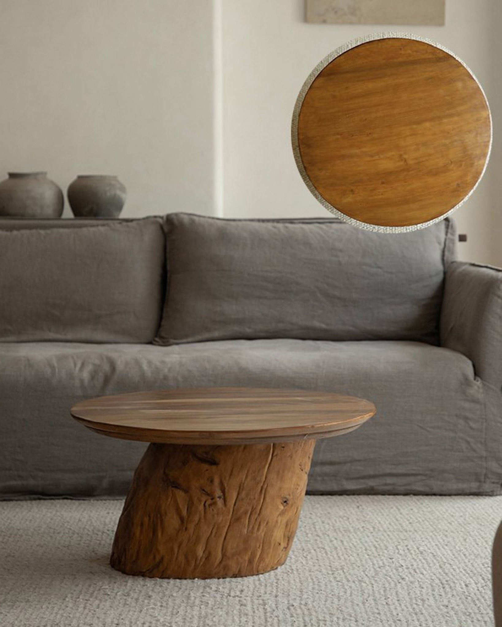 Alva Side Table in a living room, featuring a natural wood, distorted base, organic design, and curved surfaces.