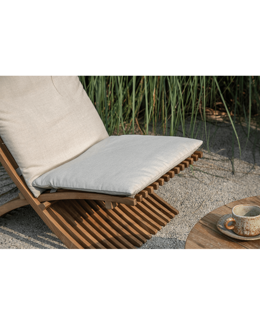 Oly Lounge Chair with cream cushion, wooden slatted design, ideal for outdoor relaxation and comfort