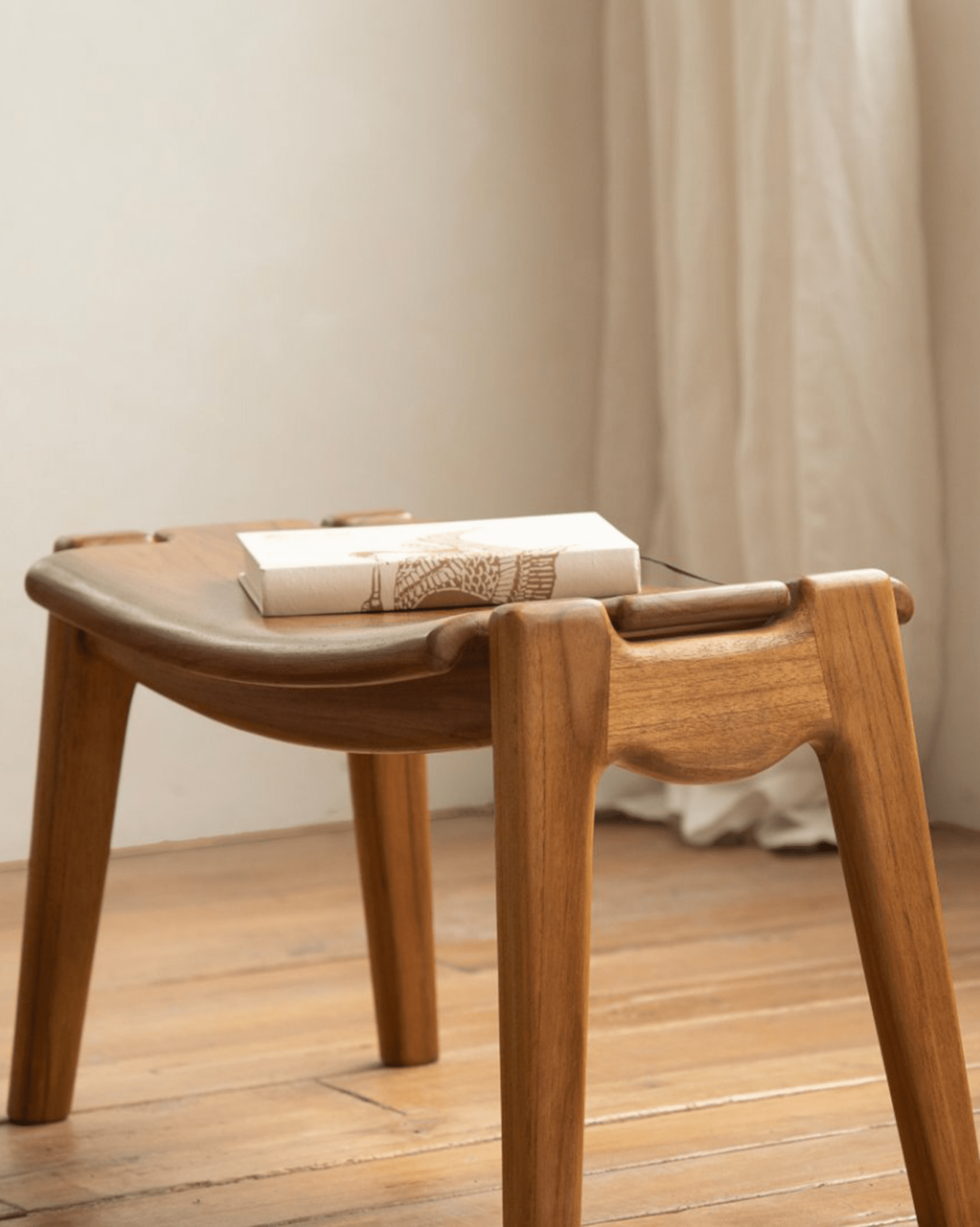 Wooden Zen footstool with ergonomic design, ideal for relaxation with Zen Armchair. Light brown wood.