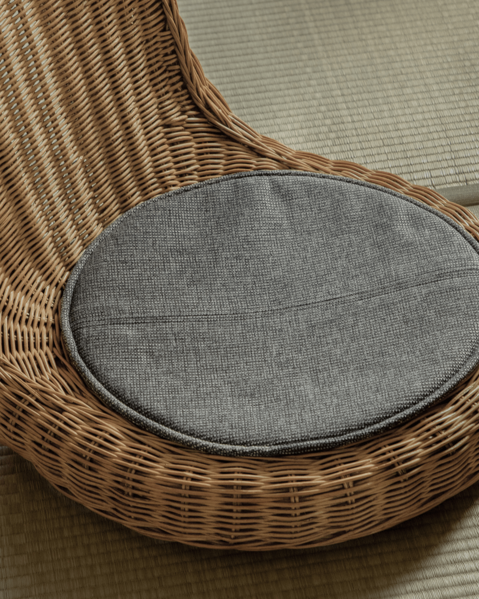 Lotus Tatami Set: Rattan chair with gray cushion and woven design. Perfect for tea room or living space.