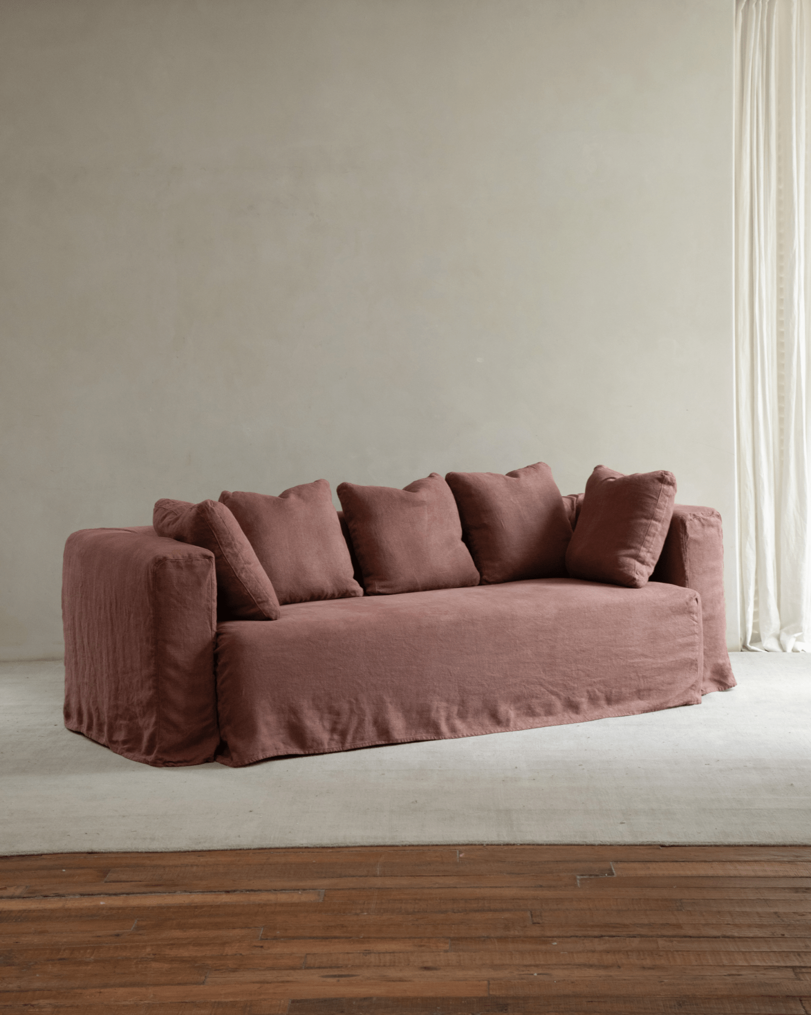 Nola Sofa in Shadow Red linen, showcasing a comfortable design in a stylish living room.