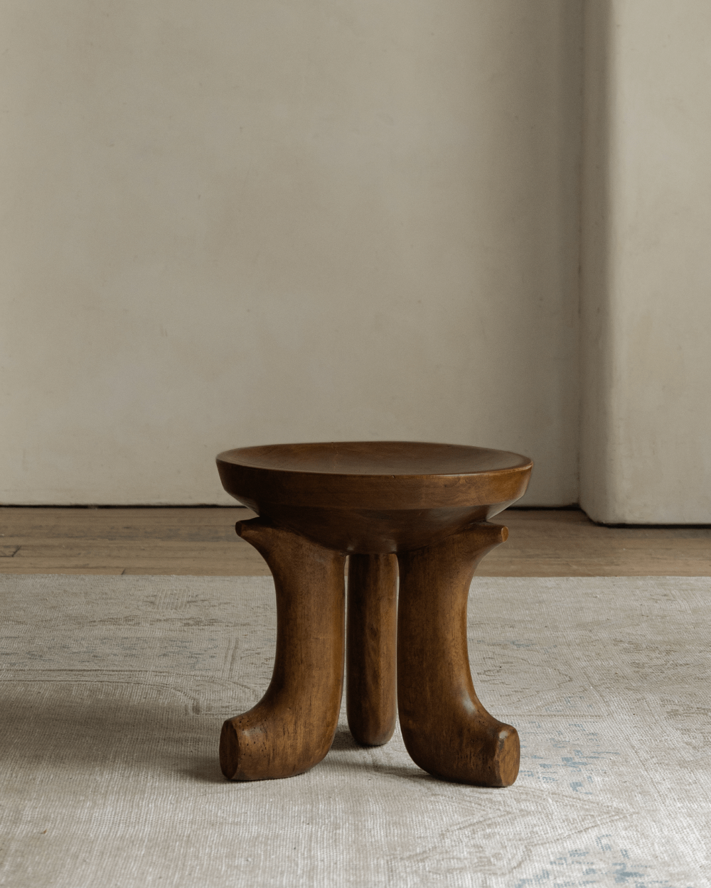 Quincy Stool - Solid wood stool with three legs, modern design, brown finish.