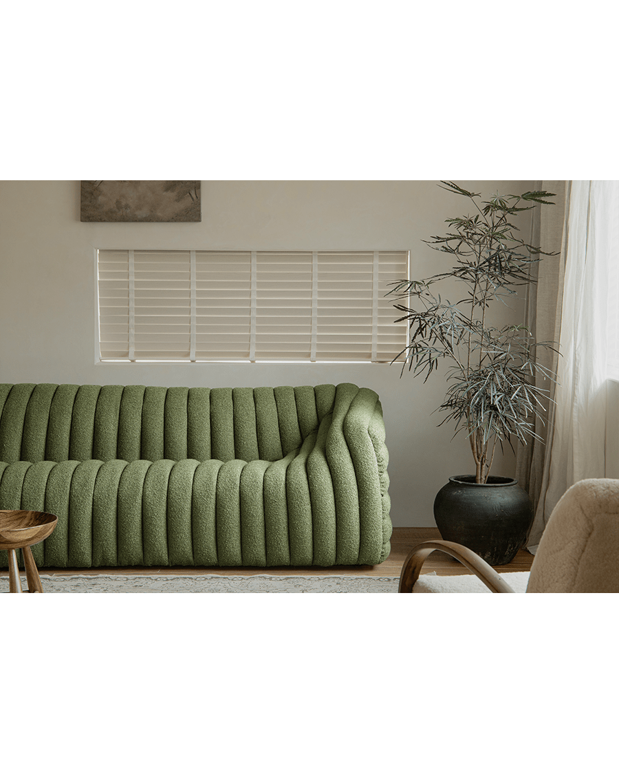 Green Miche Sofa with ribbed design in cozy living room setting, soft fabric, perfect for comfortable living