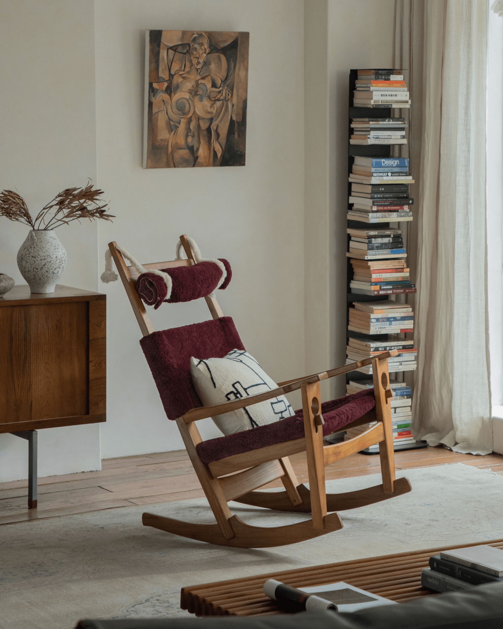 Hans Rocking Chair in Burgundy Shearling with teak frame, perfect for a cozy interior