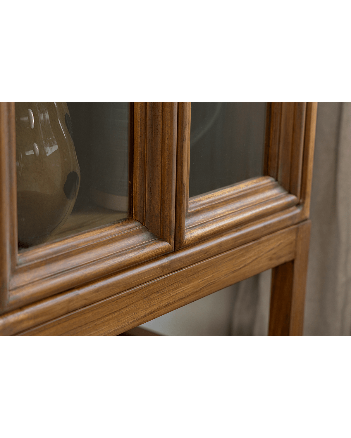 Teak Stilt Cabinet detail: glass door, teak wood grain, elegant dining room storage and display