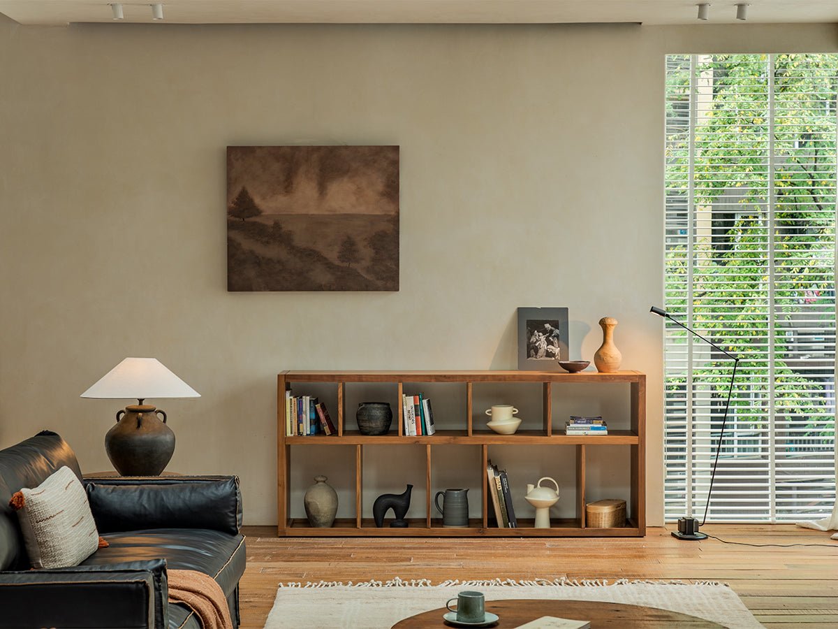 Tome Bookcase styled in a living room, natural wood bookcase with books and decor, cozy interior design.