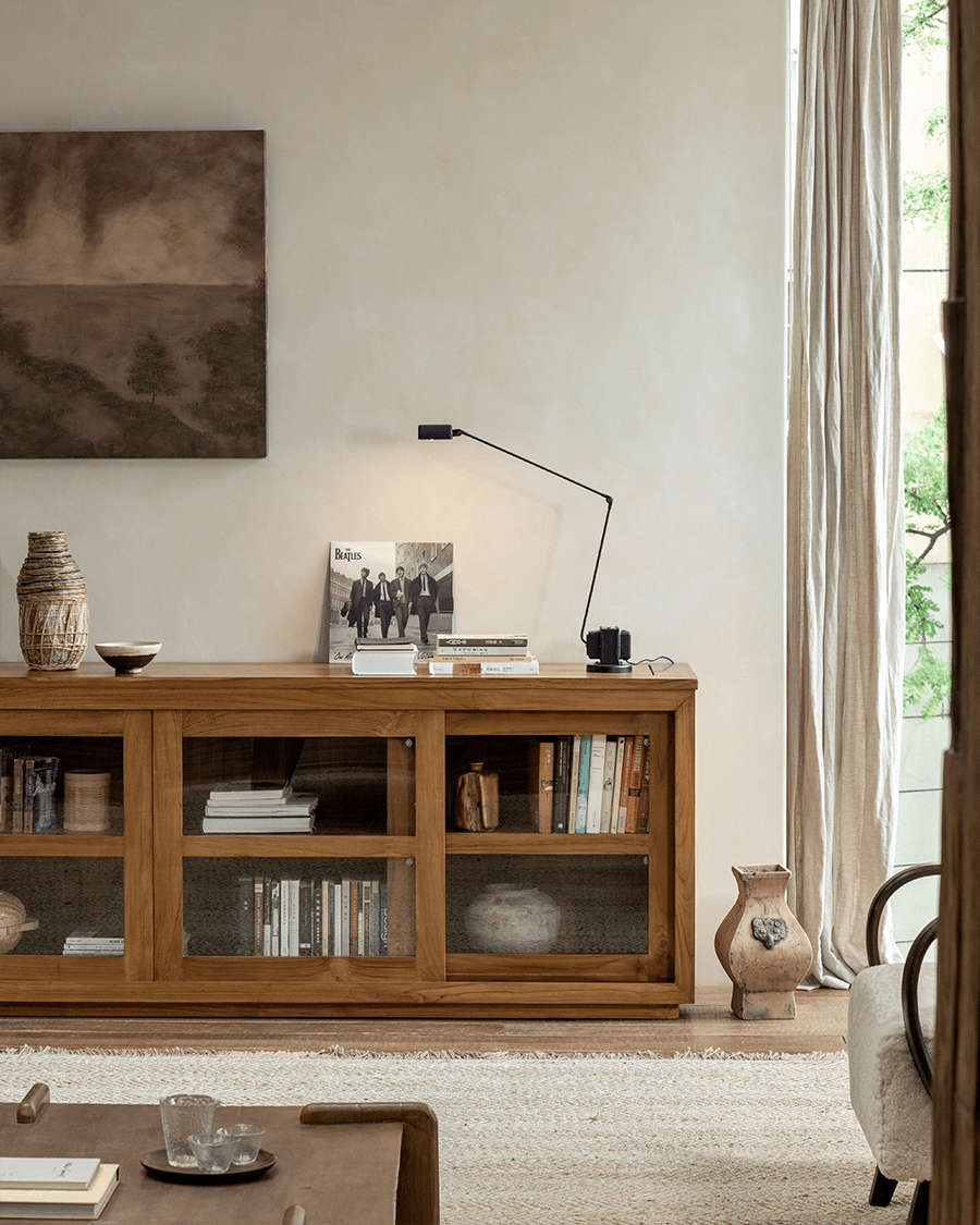 Teak wood glass front bookcase with sliding doors, display books and decor in living room, Beatles album