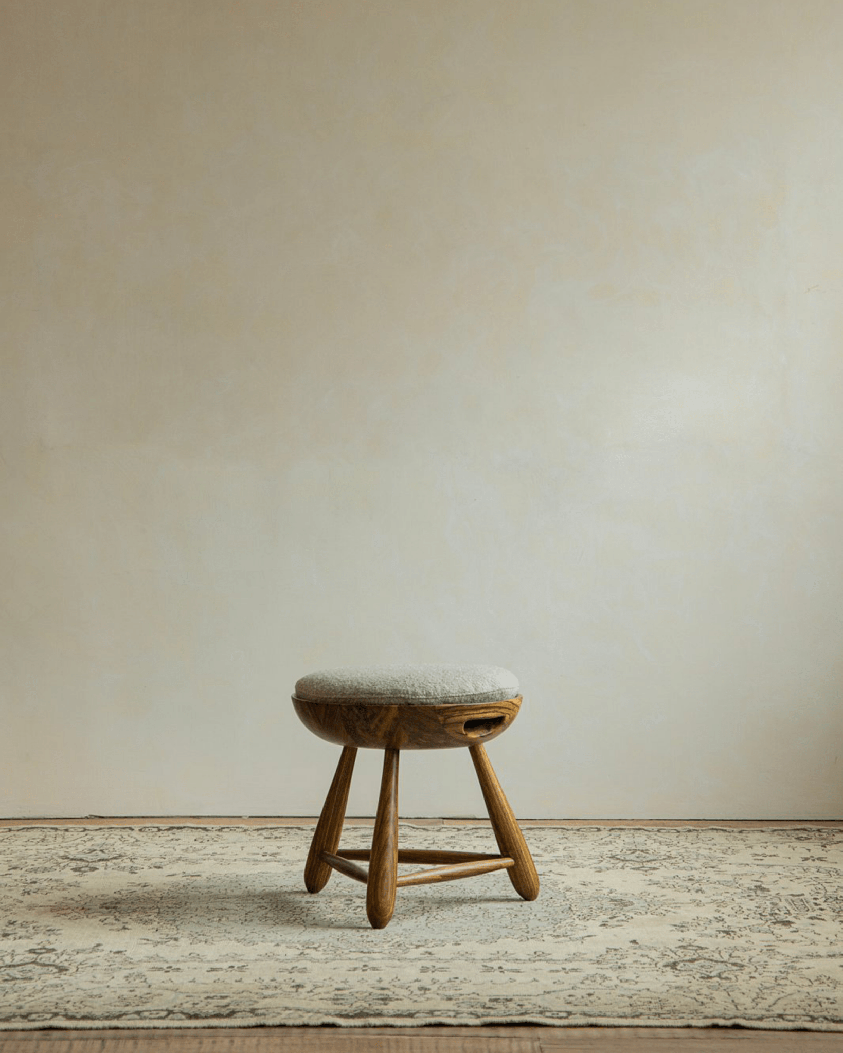 Zebrawood Mocho stool with cushioned seat, featuring an organic design and natural wood grain.