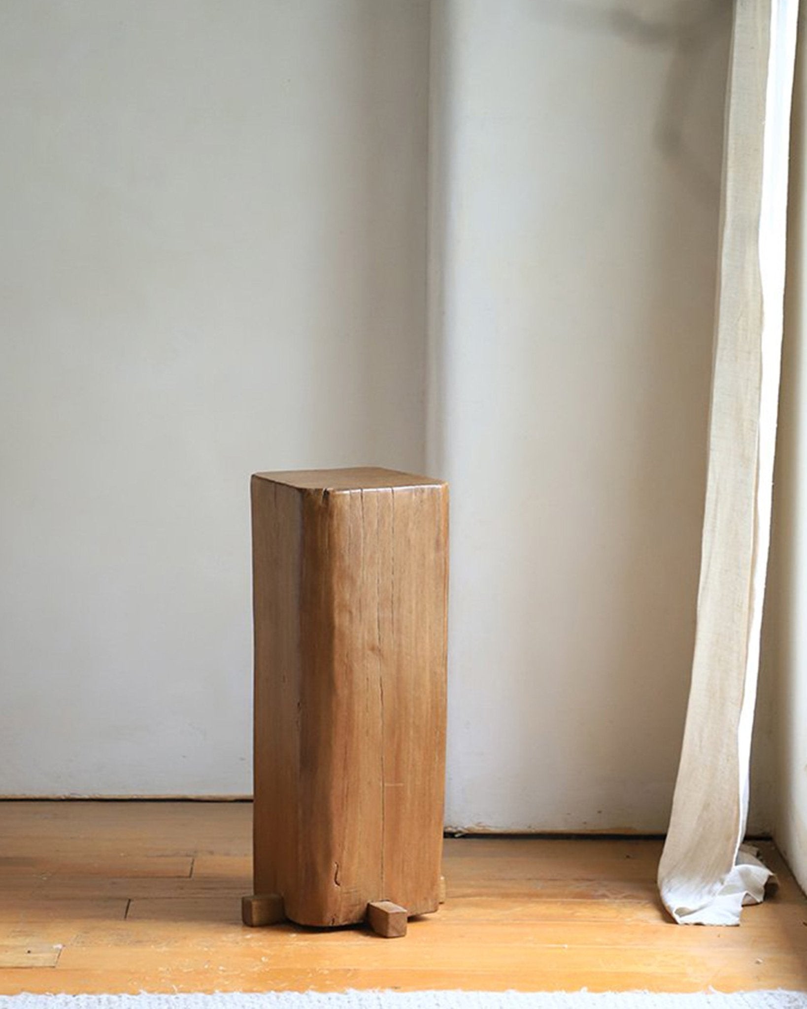 Rustic wooden pedestal, reclaimed wood, showcasing natural aging and timeless simplicity for organic interior design