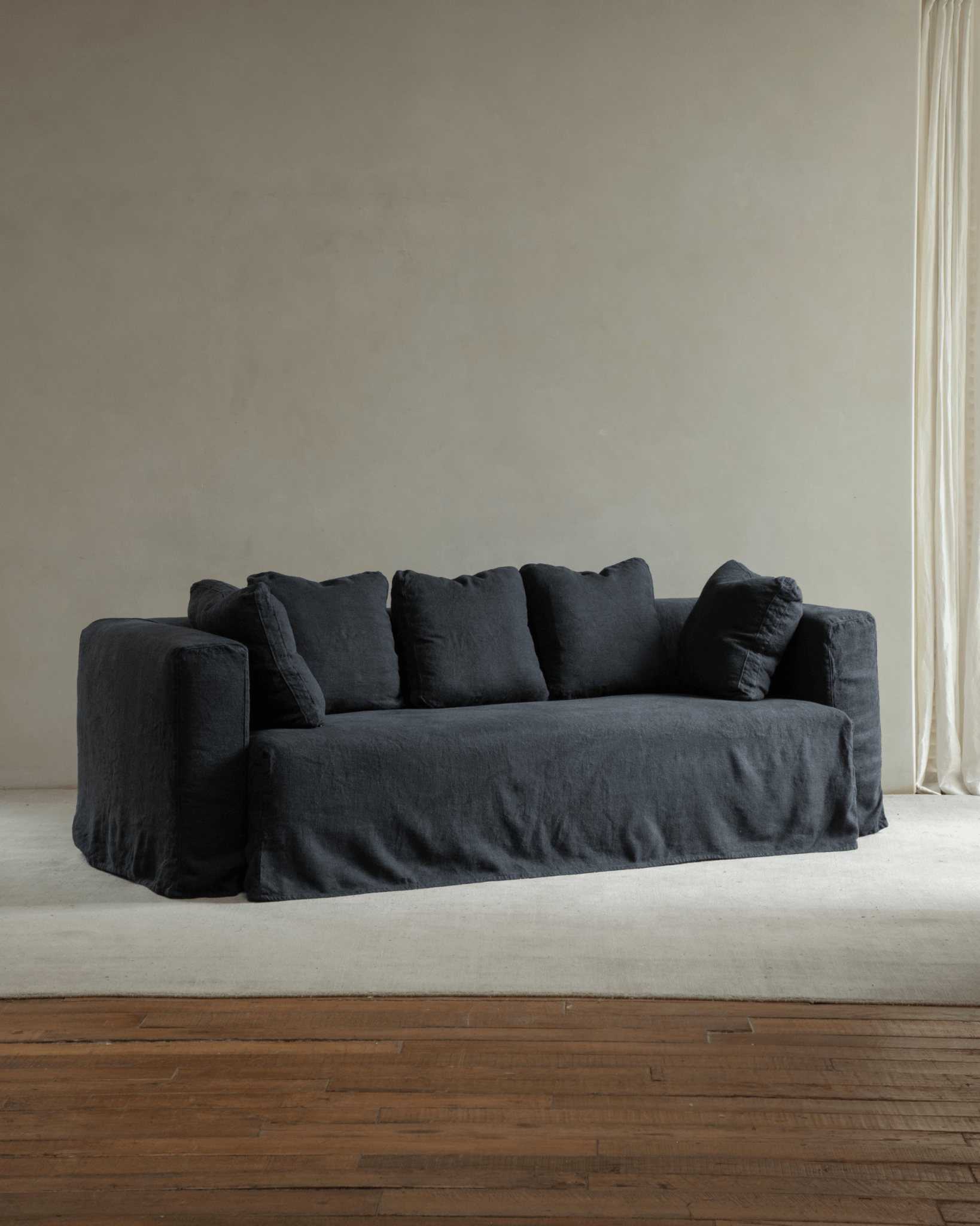 Nola Sofa in Shadow Black linen, a stylish and comfortable design for living rooms, featuring soft, down-filled cushions