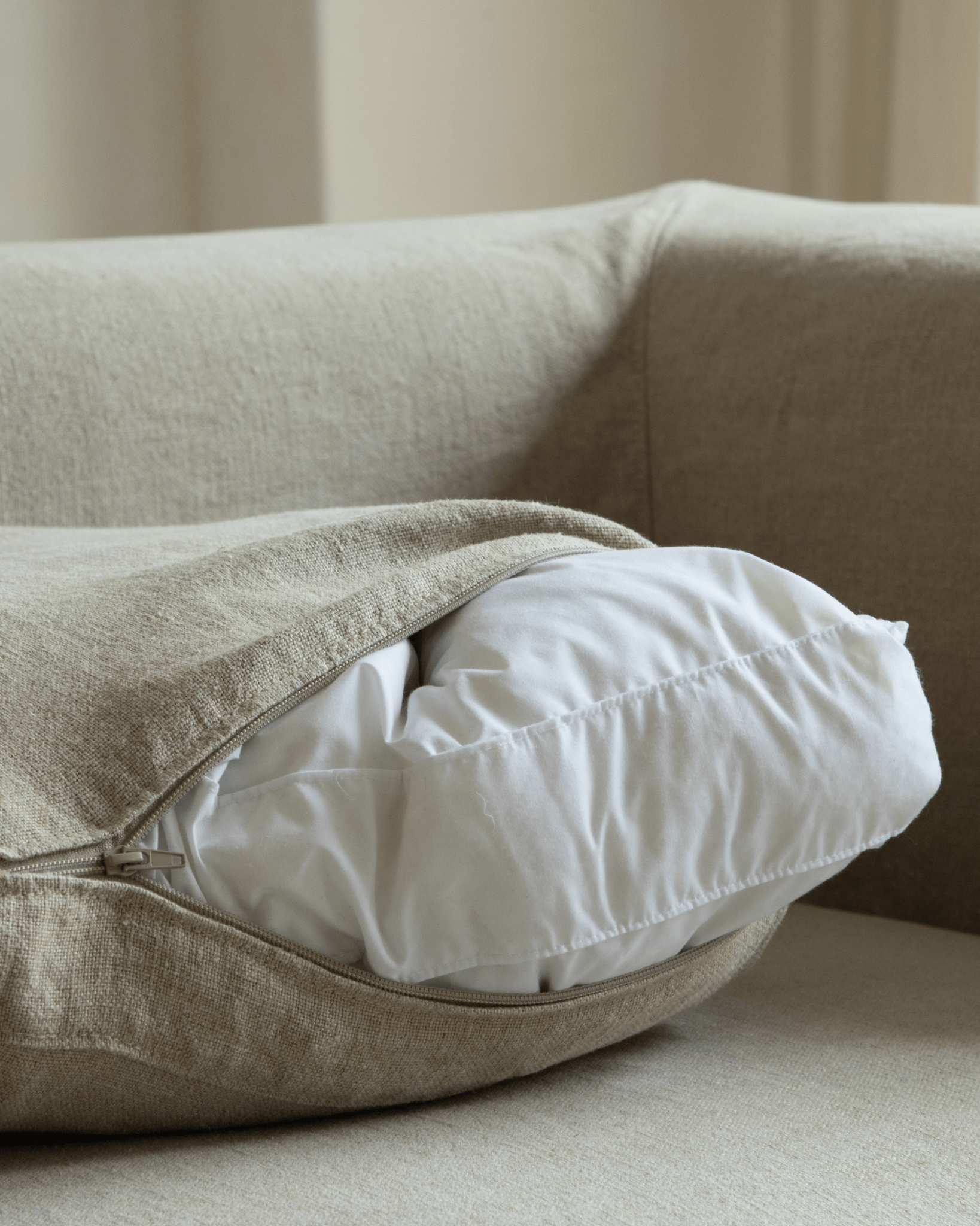 Nola Sofa detail: Beige linen cushion with removable cover and soft, down-filled interior for comfortable living