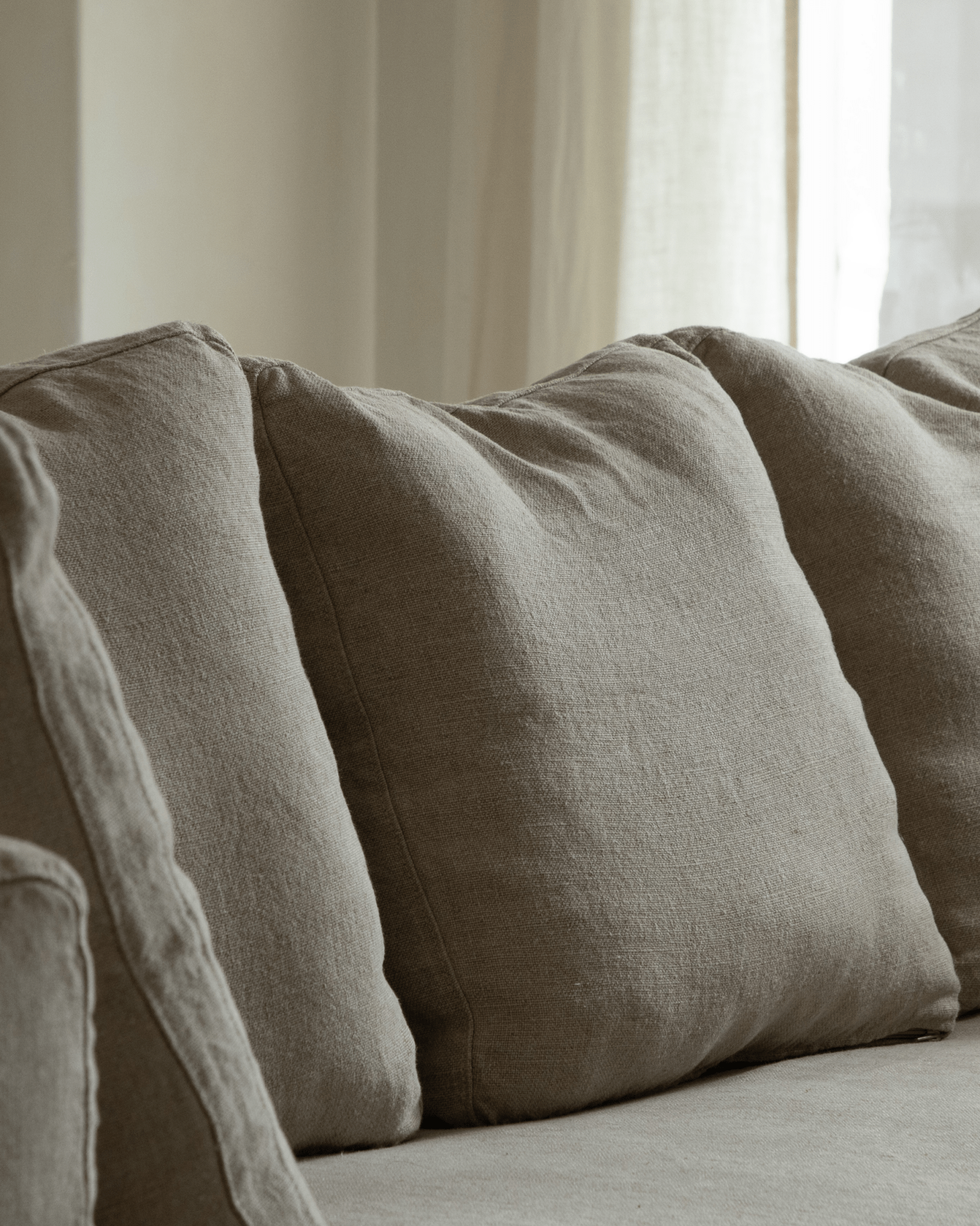 Nola Sofa detail: Close-up of natural linen cushions, breathable fabric, comfortable design