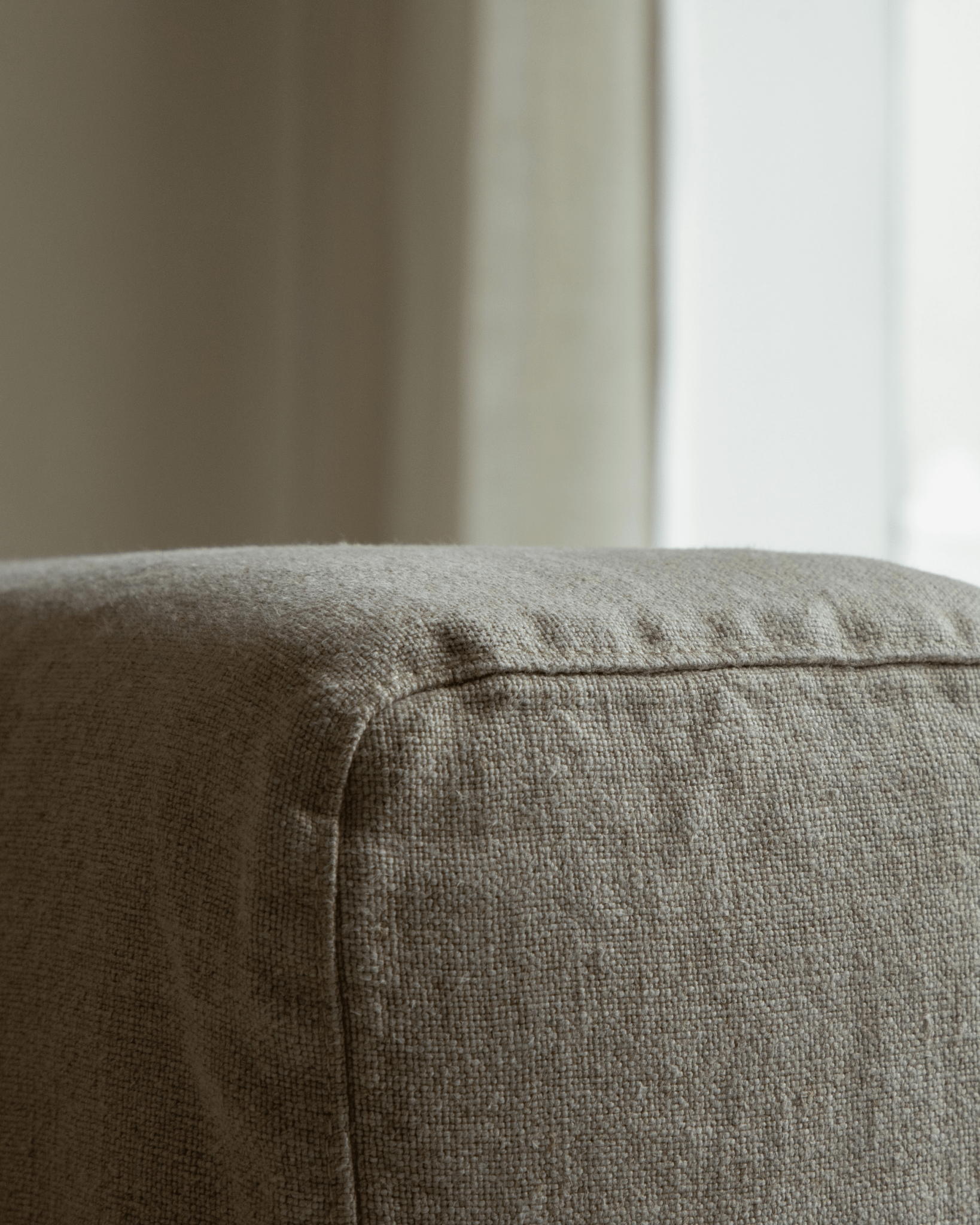 Nola Sofa detail: Close-up of natural linen fabric corner, breathable fabric, comfortable design
