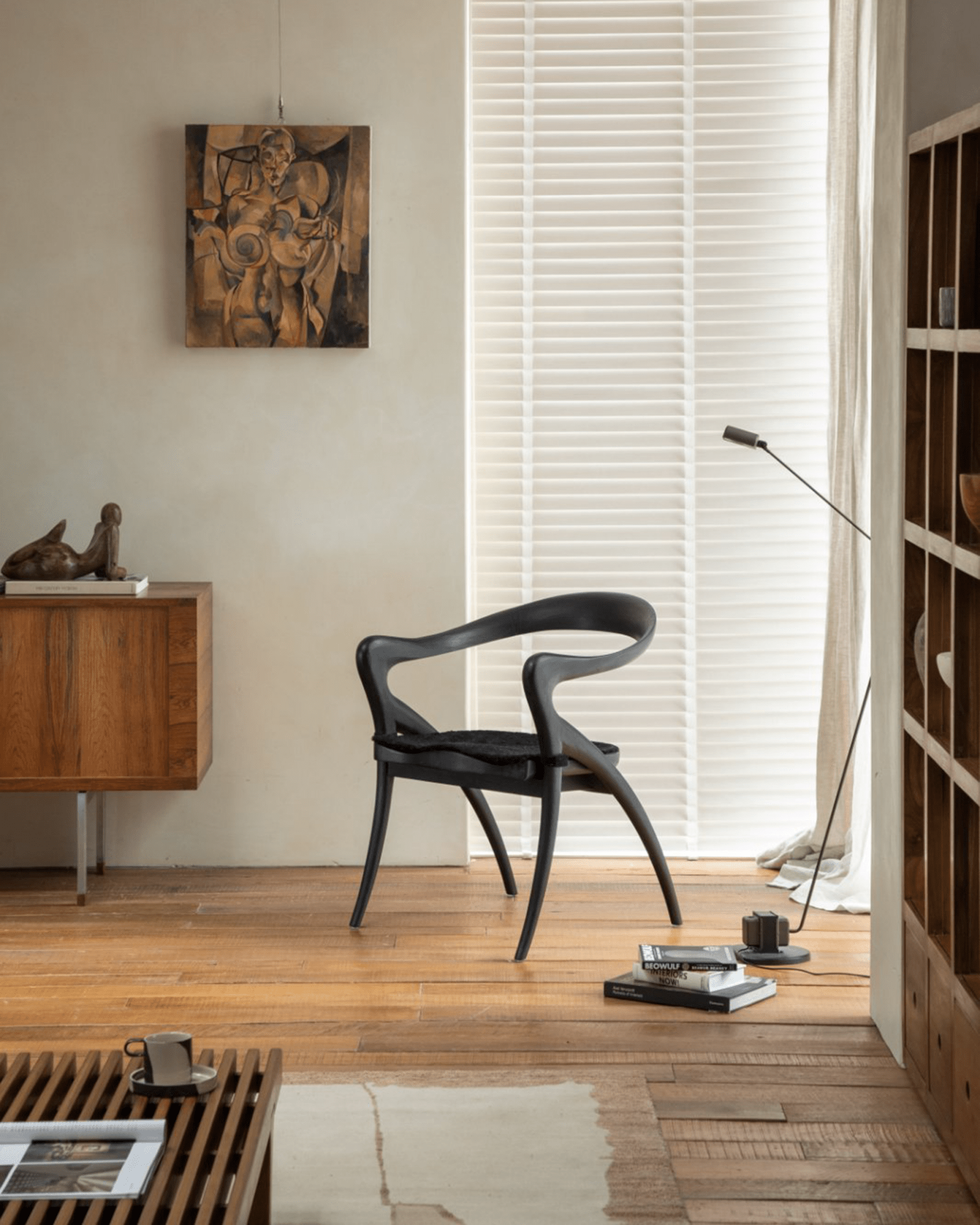 Olivia Chair in black in modern interior, solid teak wood, curved back, contoured seat, modern design
