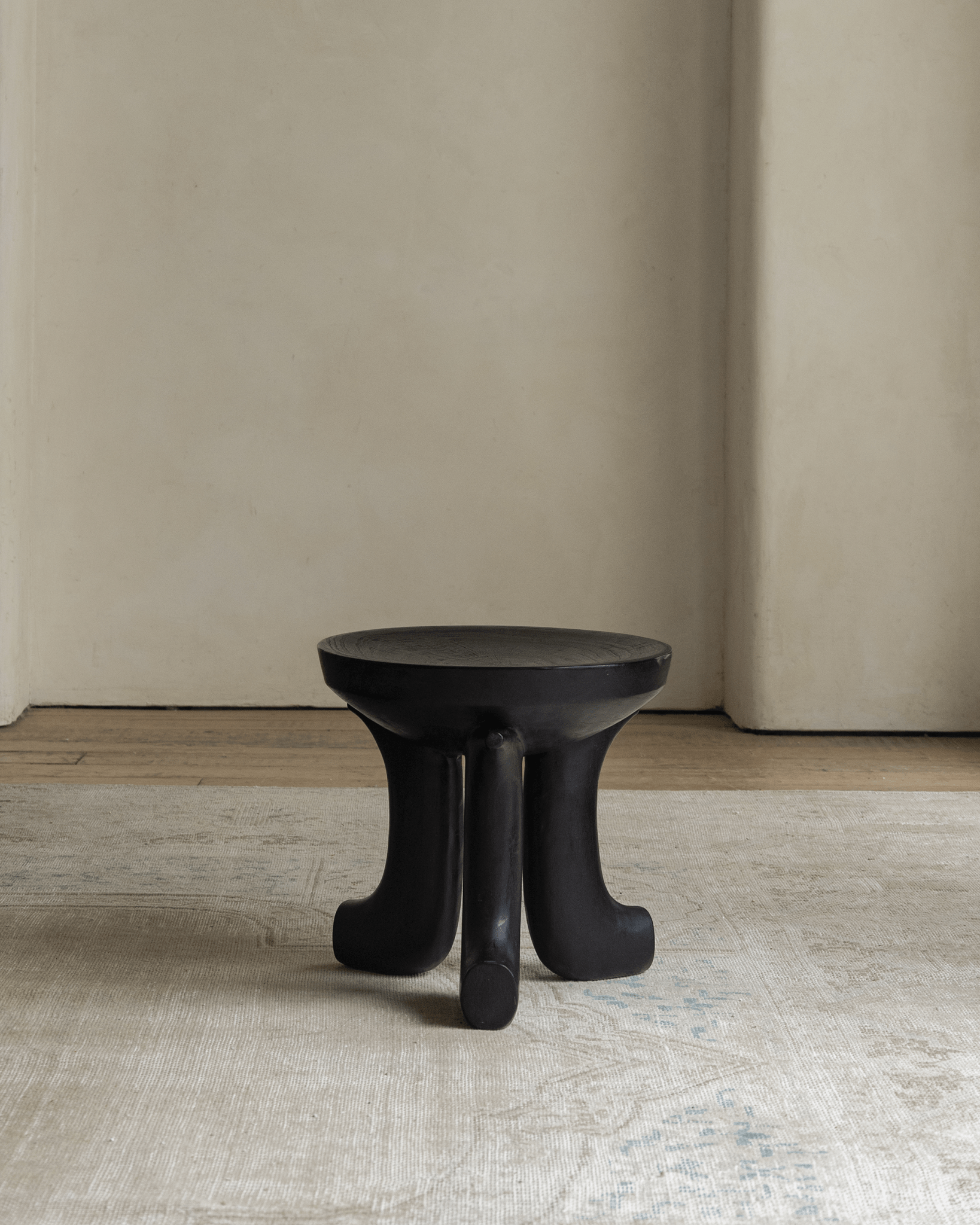 Quincy Stool - Black solid wood stool with three legs, modern design, perfect for home decor.