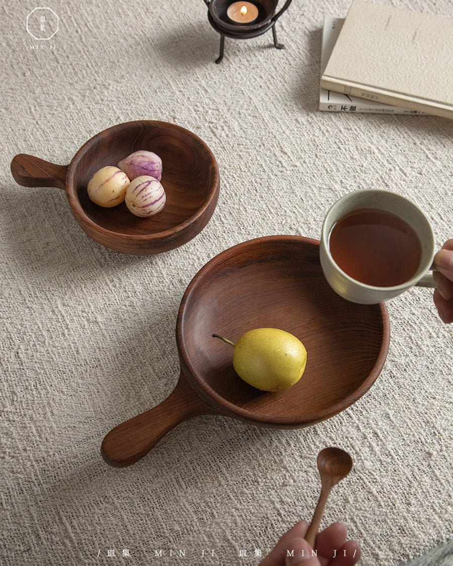 Fany Tray in teak wood, styled with pear, tea cup, and striped fruit.