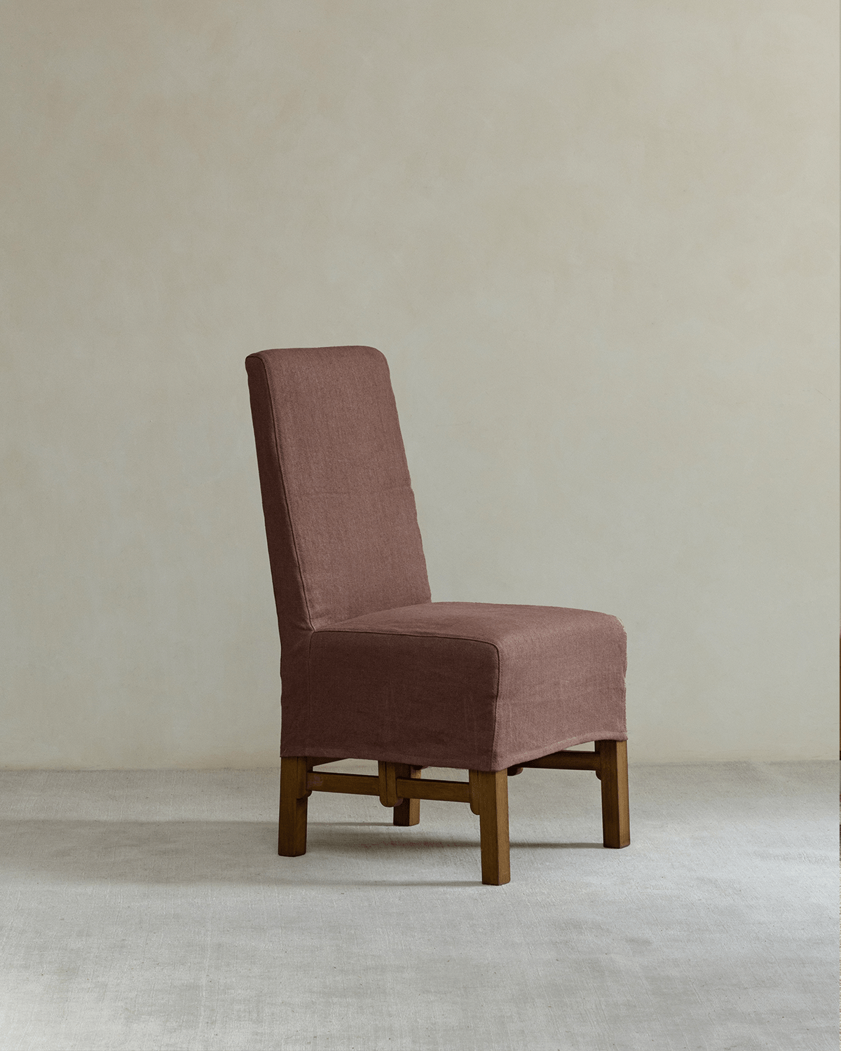 Feast Dining Chair with brown linen slipcover, wood frame, perfect for modern settings.