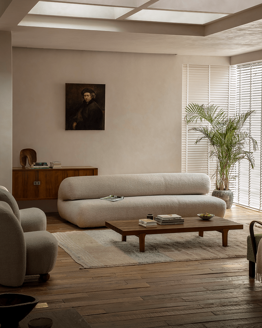 Beige Wave Bouclé Sofa in stylish living room with soft bouclé fabric and wave design. Modern interior with wooden accents.