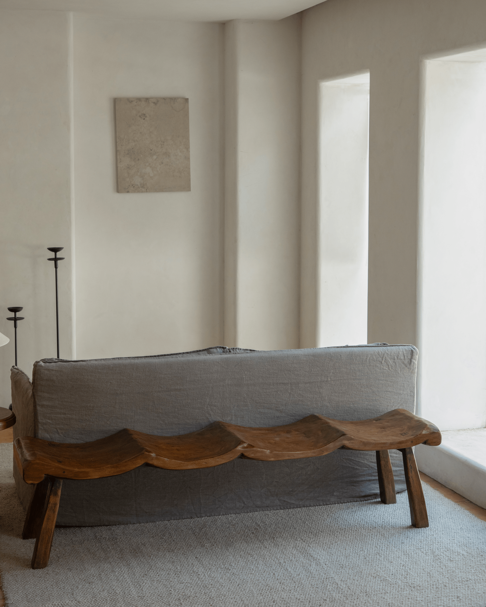 Tildes Bench, a wooden bench with a carved seat, in a minimalist interior setting. Solid wood furniture.