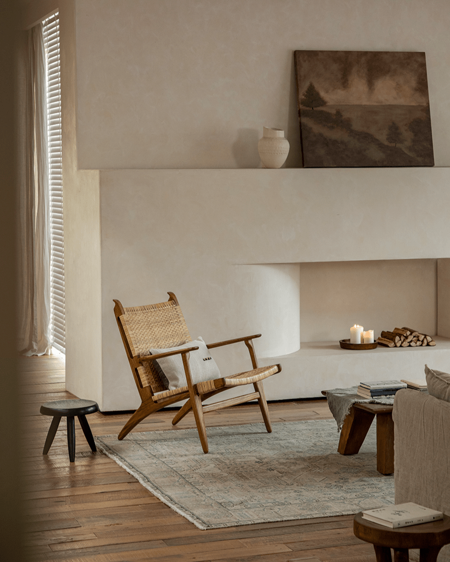 Horn Lounge Chair in cozy interior setting, oak frame and natural rattan seat, ergonomic design.
