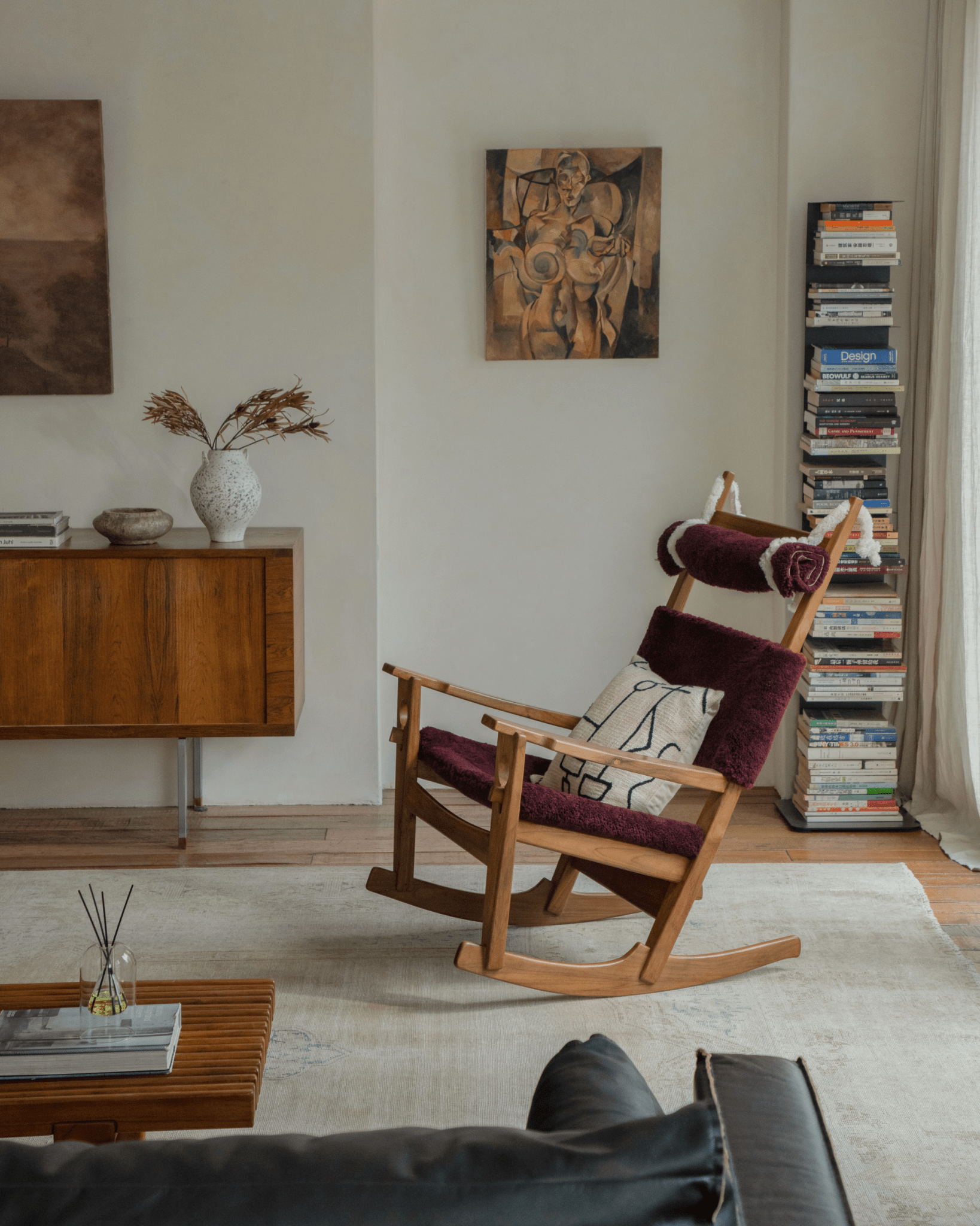 Hans Rocking Chair in Burgundy Shearling, Danish design with teak frame, cozy interior, Juhl Design books.