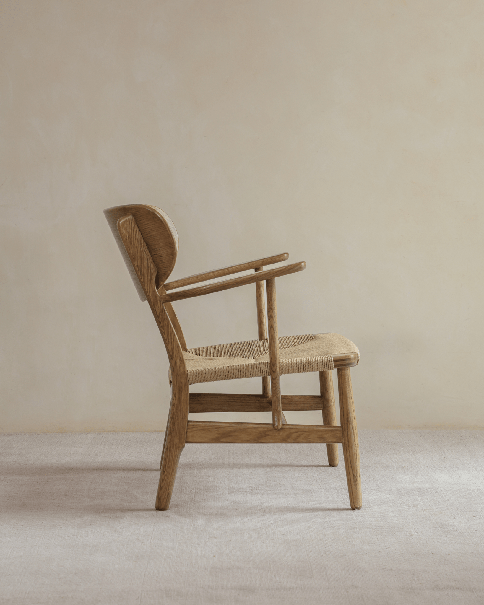 CH22 Lounge Chair in natural oak, Scandinavian design, with woven paper cord seat.