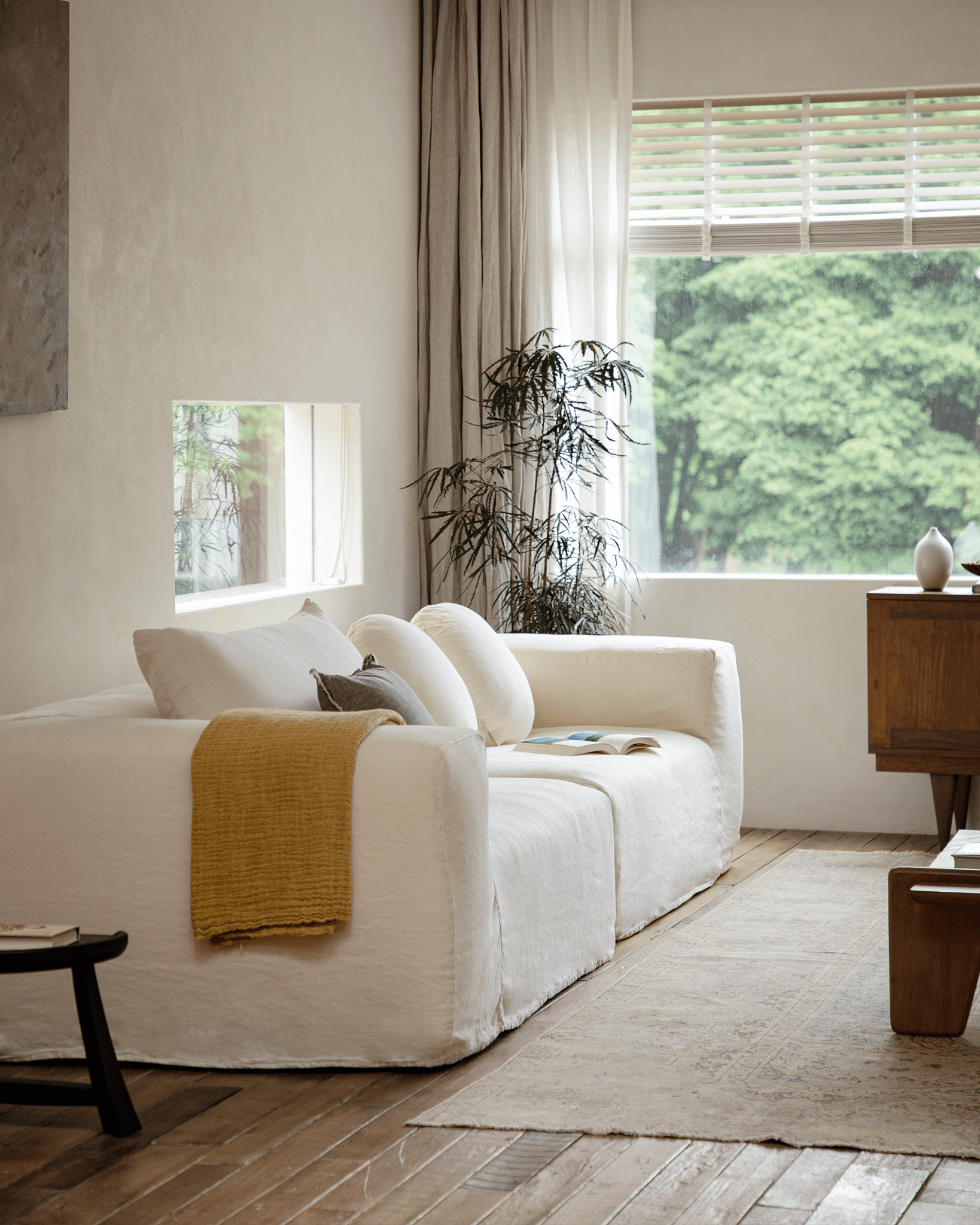 Doma Sectional Sofa in white linen, wide armrests, modular design, bright living room