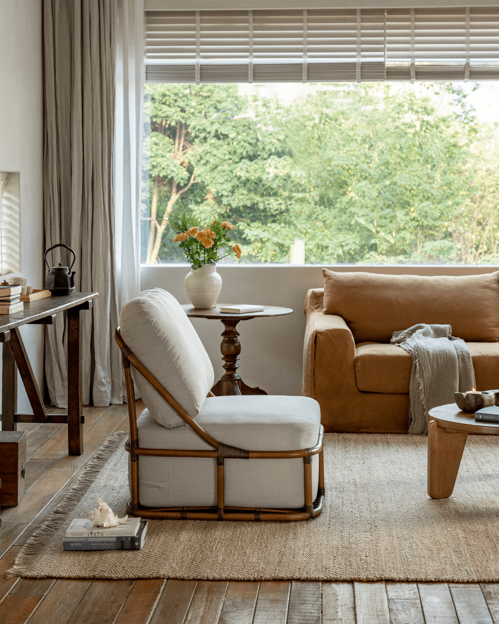 Tofu Lounge Sofa in living room. Natural rattan frame and light gray cushion, promoting relaxed seating.