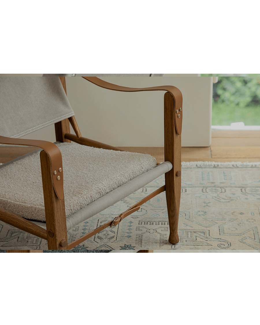 Safari Chair detail: Leather armrest and fabric seat with US Red Oak frame
