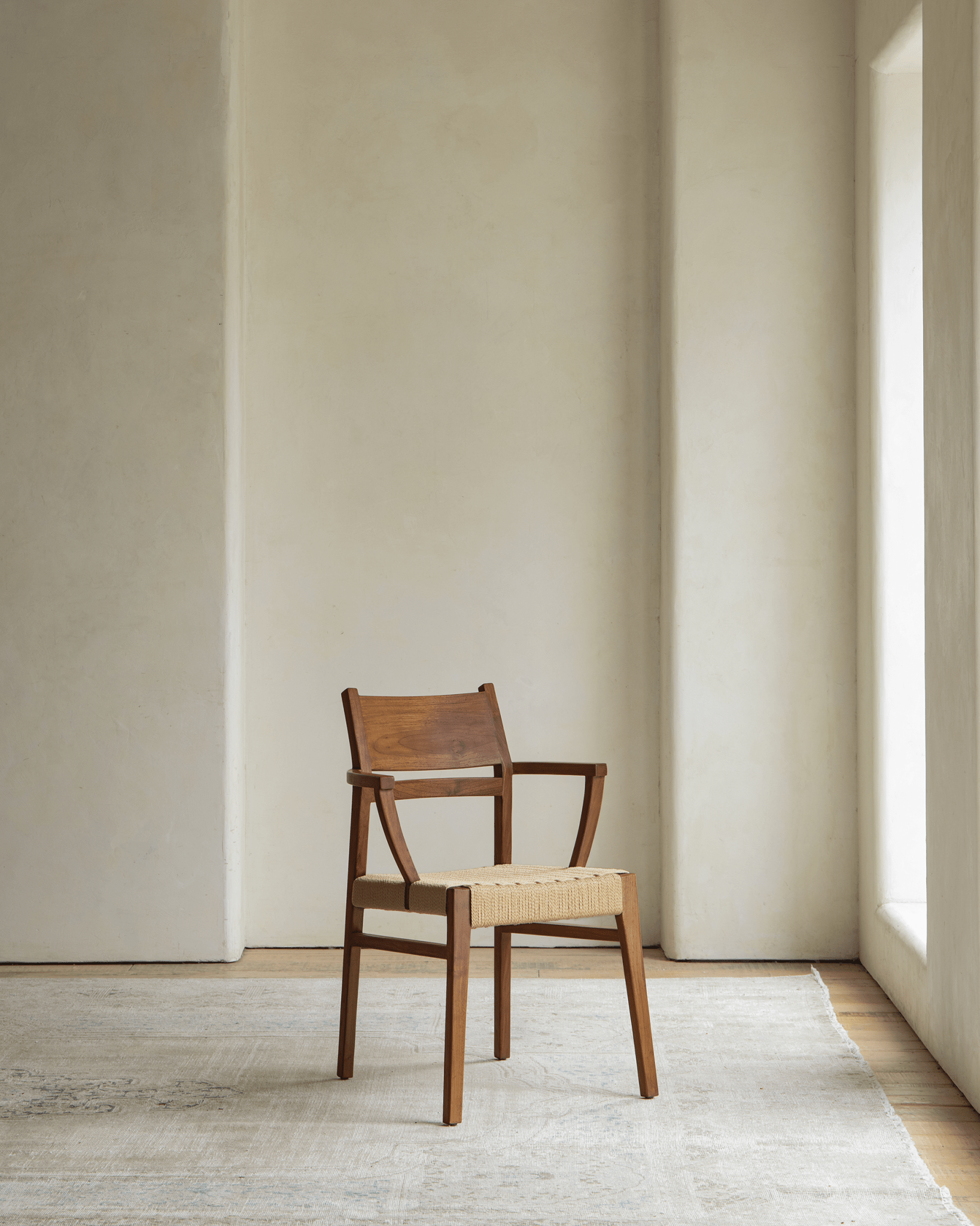 Hug Chair with wooden frame and woven seat, modern design for a warm living space