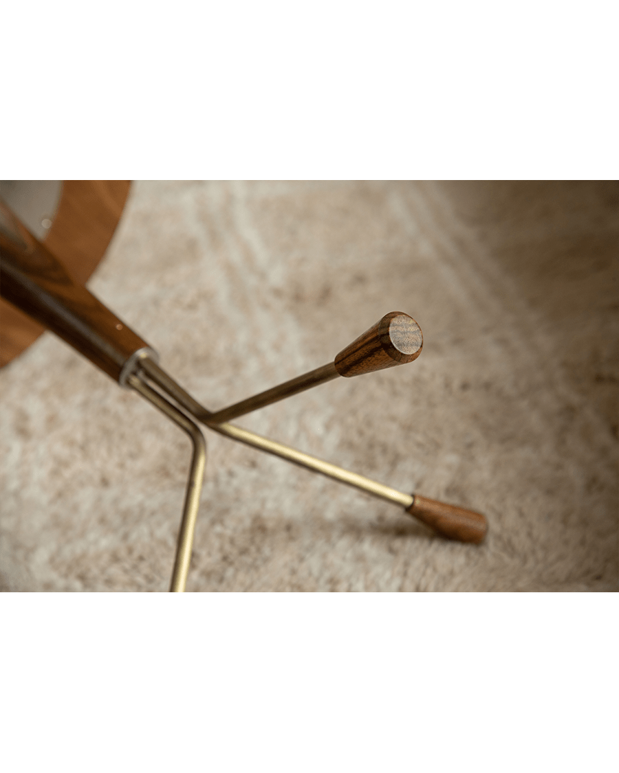 Larsson Side Table detail: Brass legs with wooden accents, close-up view, aged brass finish.