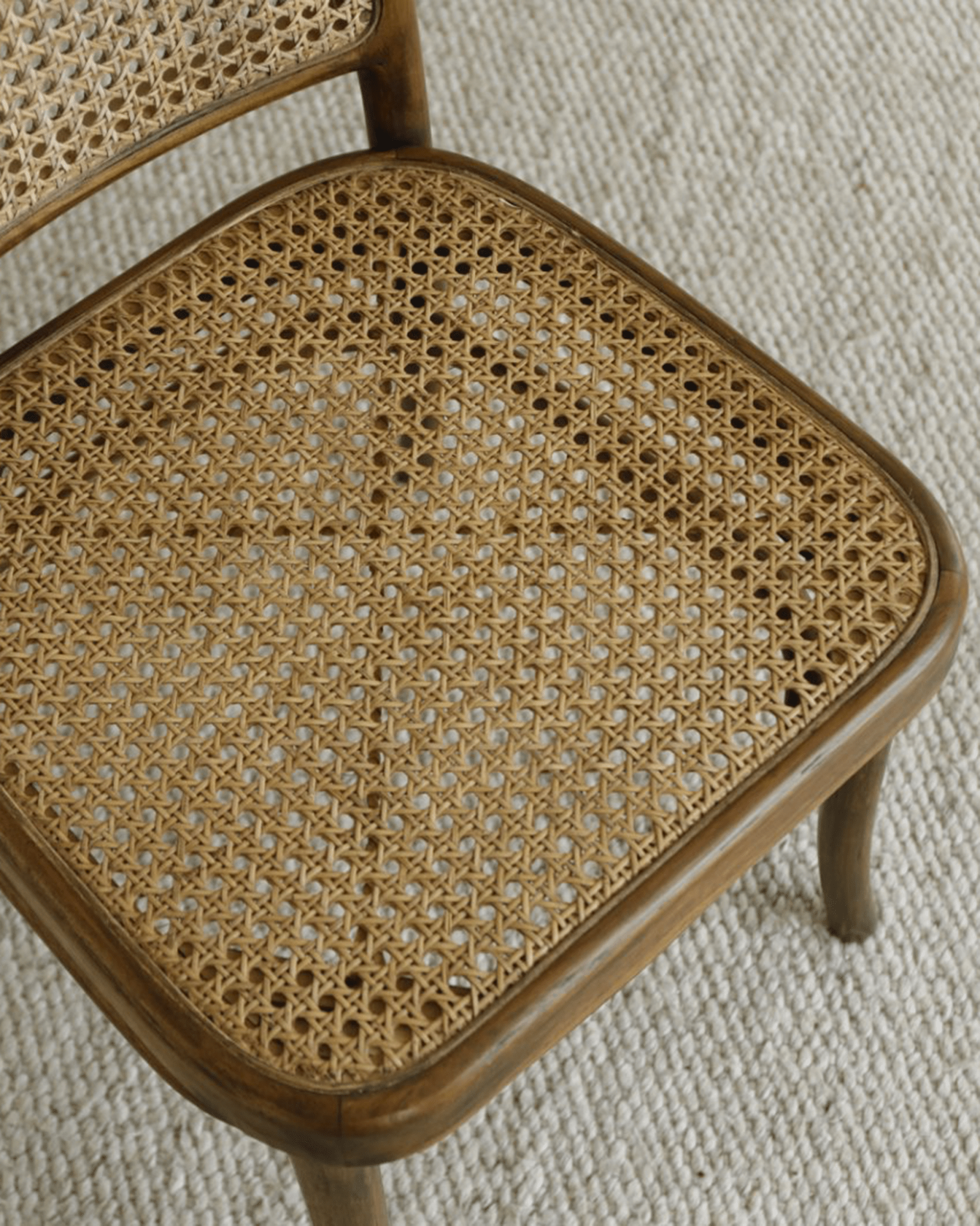 NO.811 Chair detail: Teak frame and natural rattan seat. Ergonomic design for dining and living spaces.