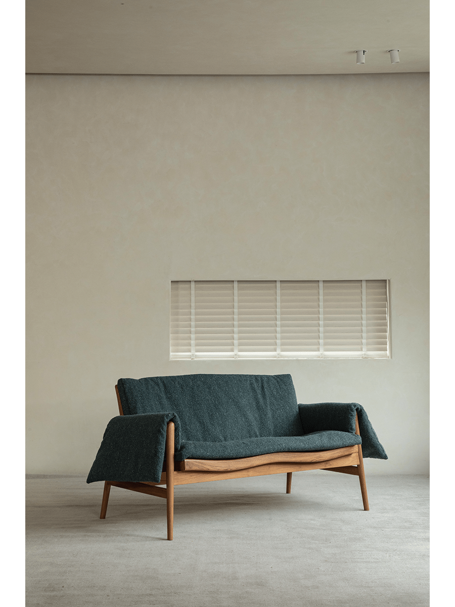 Teak wood garden lounge chair with teal cushion and blanket, perfect for indoor or outdoor use