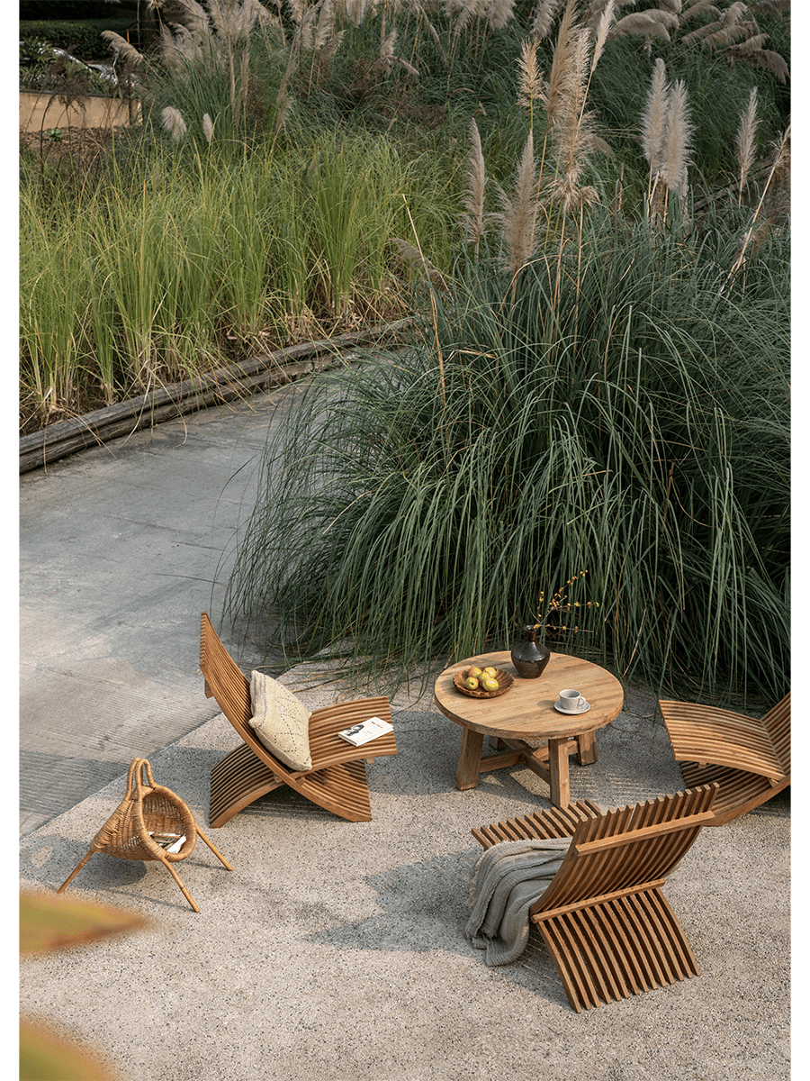 Oly Lounge Chairs in a serene outdoor setting, wooden slatted design, ideal for relaxation and comfort.