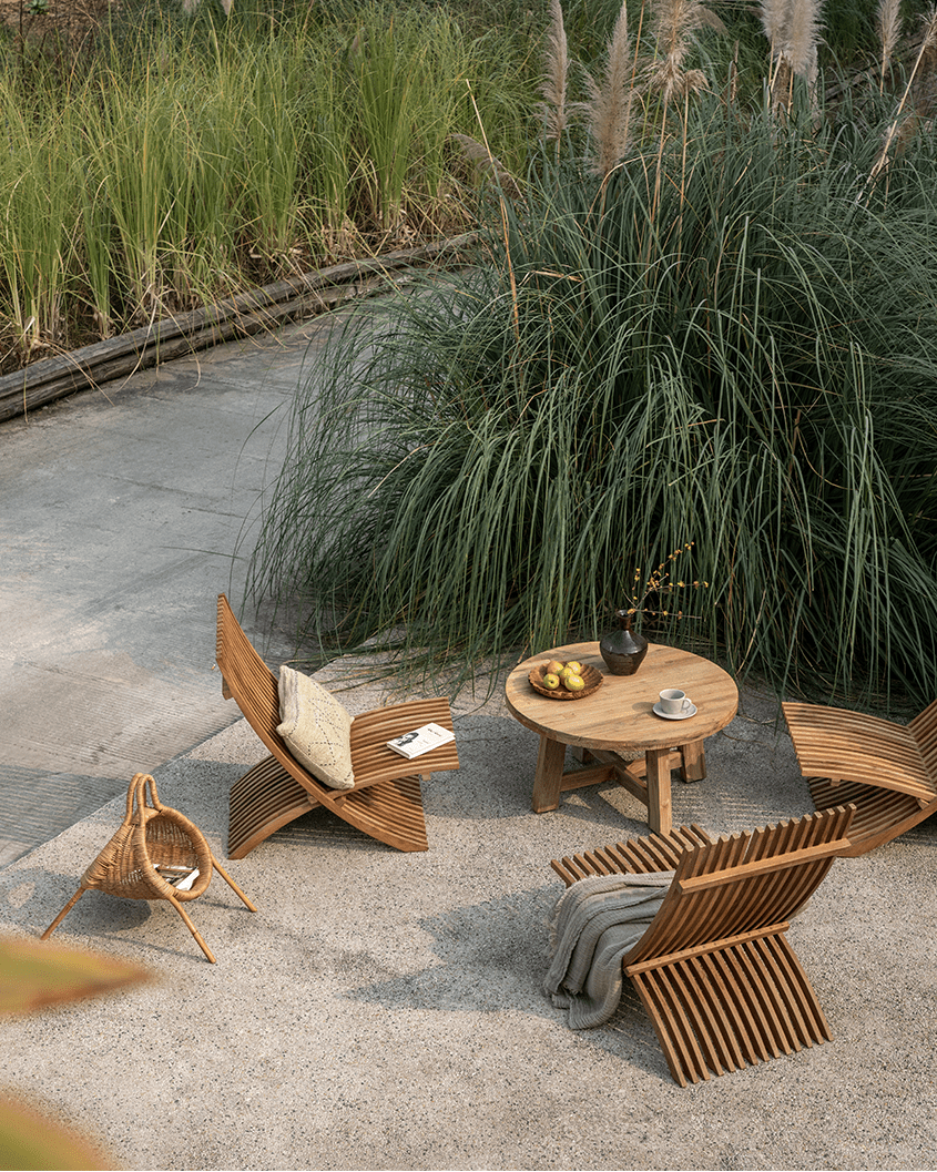 Oly Lounge Chairs in a serene outdoor setting, wooden slatted design, ideal for relaxation and comfort.