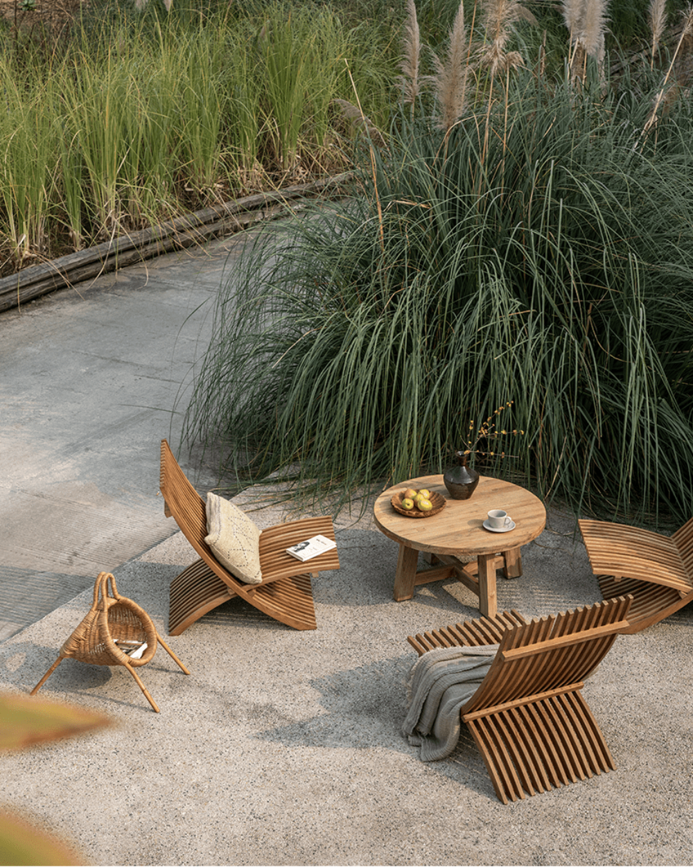Oly Lounge Chairs in a serene outdoor setting, wooden slatted design, ideal for relaxation and comfort.