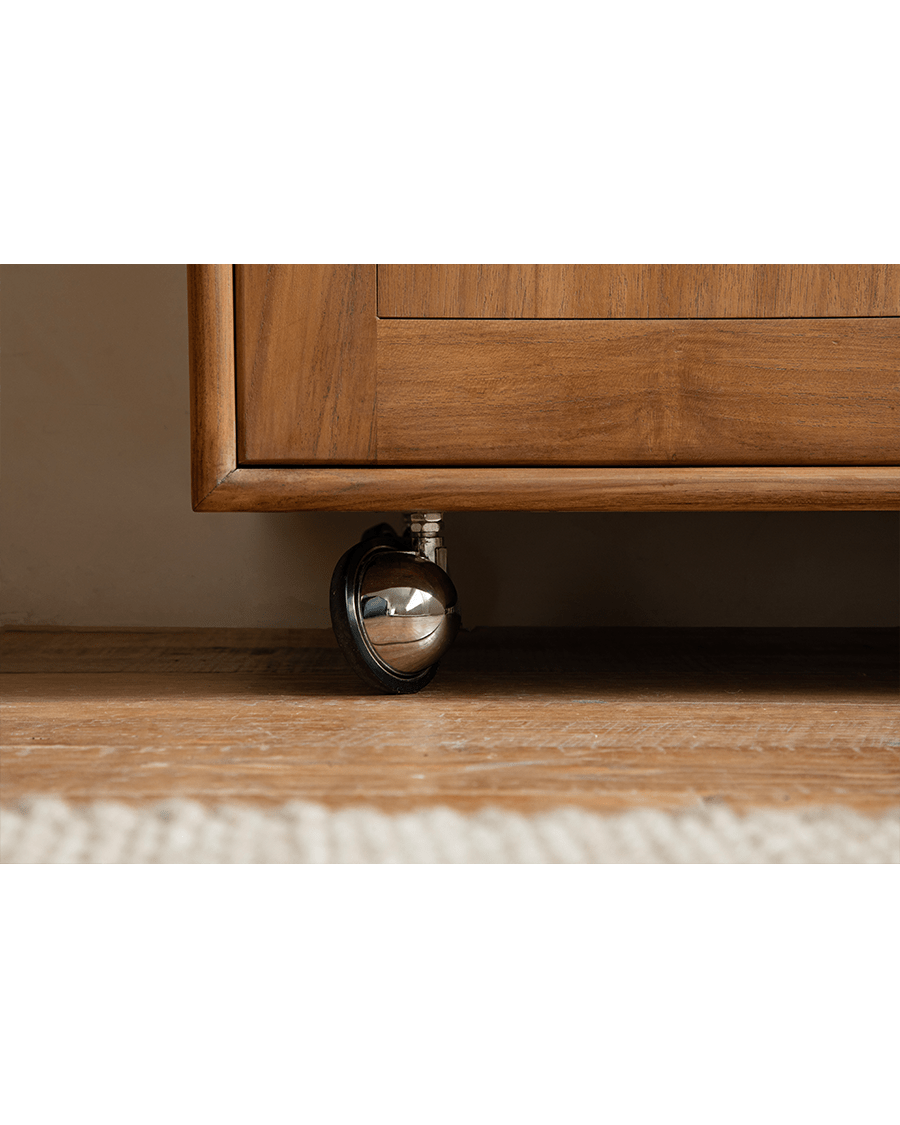 Lidi Display Cabinet detail, showing teak wood cabinet corner and universal wheel for mobility