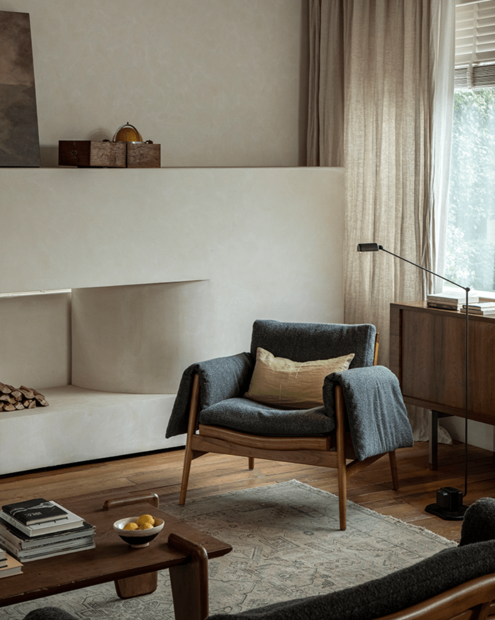 Teak wood garden lounge chair, dark grey cushion and blanket, indoor modern design, wooden frame