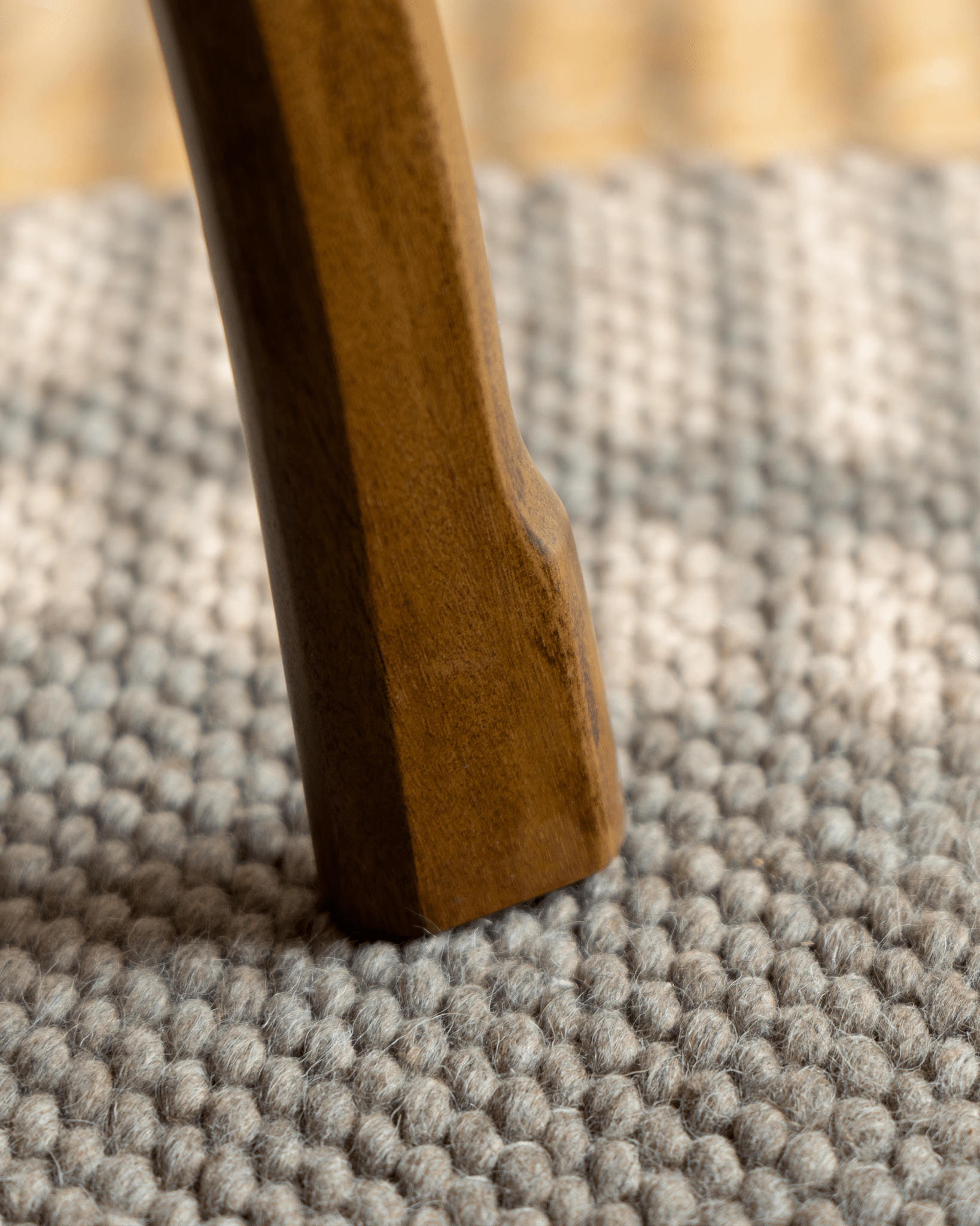 Ele Round Side Table leg, Phoebe wood detail, vintage finish, resting on textured rug